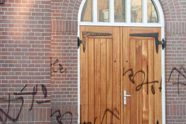 faithbased_nonprofit Front doors of a church with graffiti